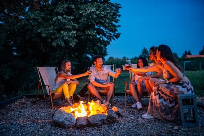 Group of friends enjoying near a campfire