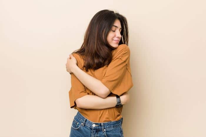 Woman hugging herself